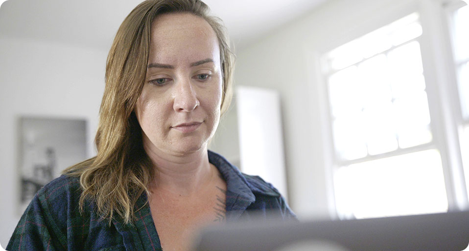 Woman looking at laptop screen