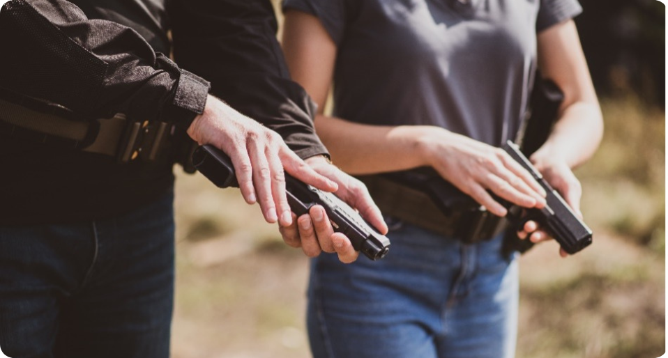 Two people holding firearms